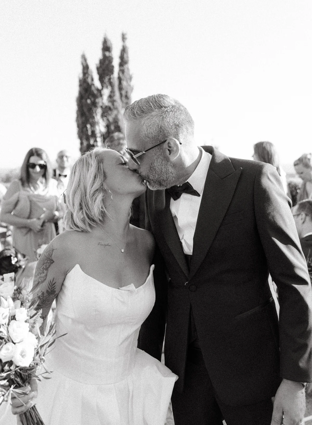 The bride and groom kissing, in black and white