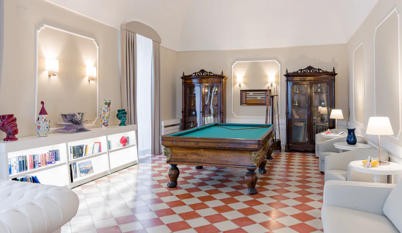 The lounge at Casa Isabella, with a billiard table and a chequered floor