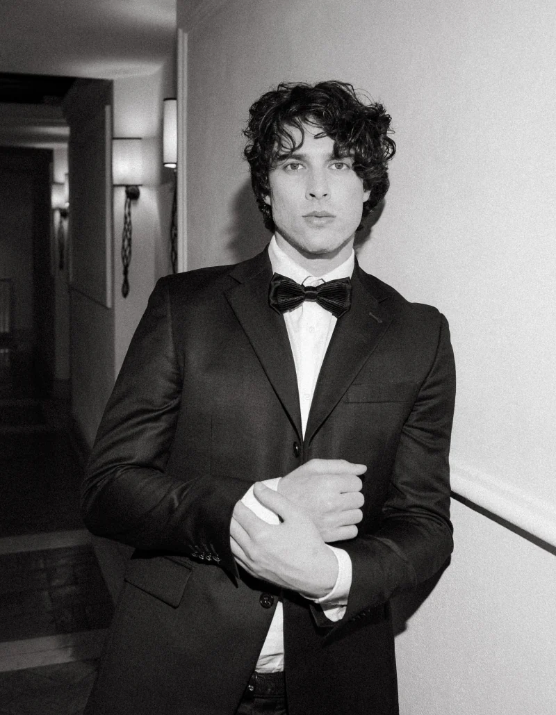 Black-and-white portrait of a groom in a tuxedo and bow tie