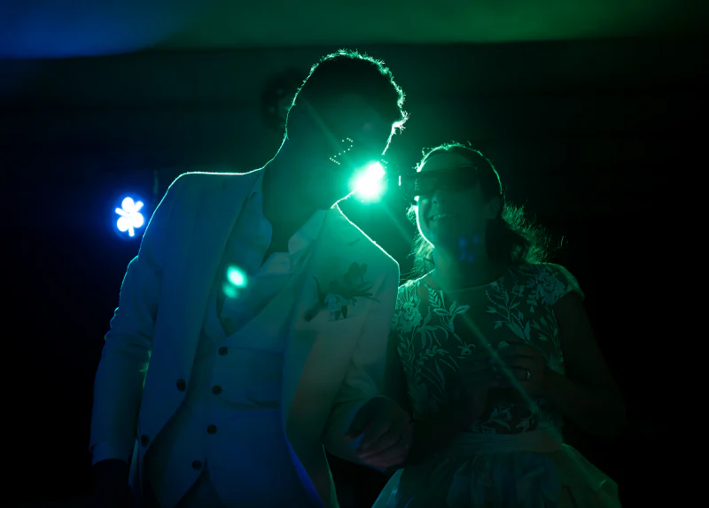 A couple in silhouette against green light