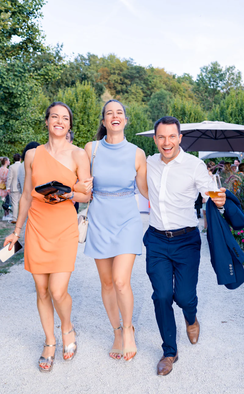 Guests walking arm in arm, laughing
