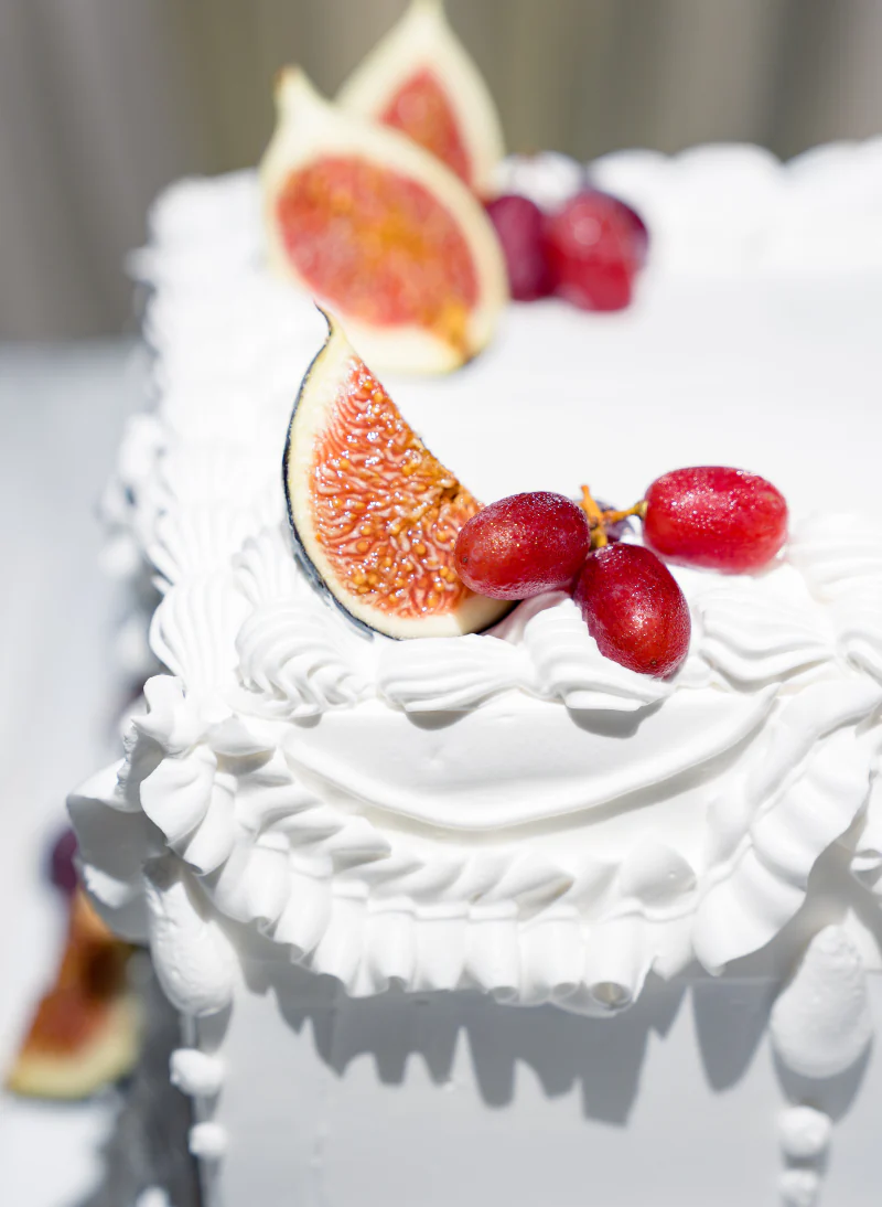 Wedding cake topped with figs and grapes