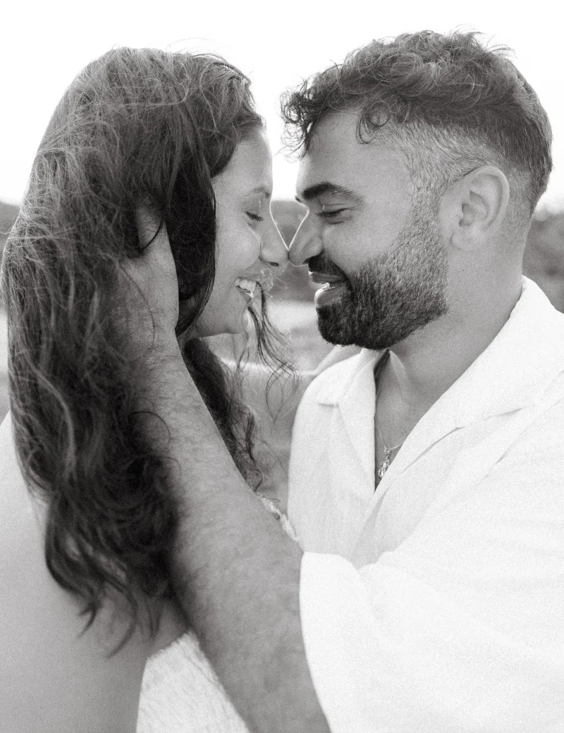 Black-and-white: a couple about to kiss, foreheads touching